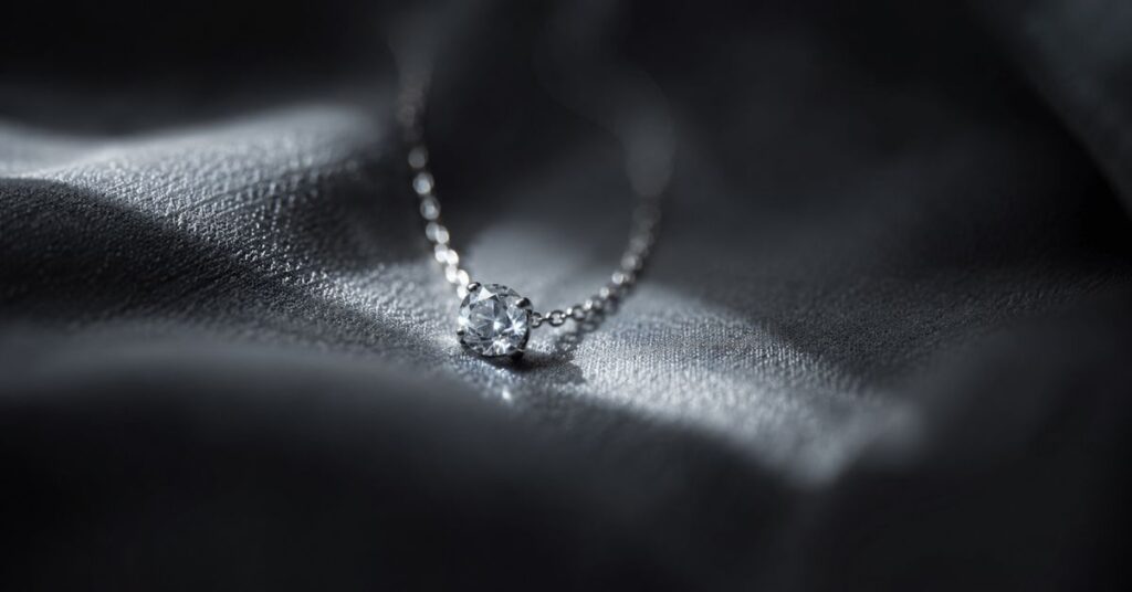 A delicate ring on draped fabric lit by a narrow beam of morning light | featured image for How Lucky I Am on Sayspire.
