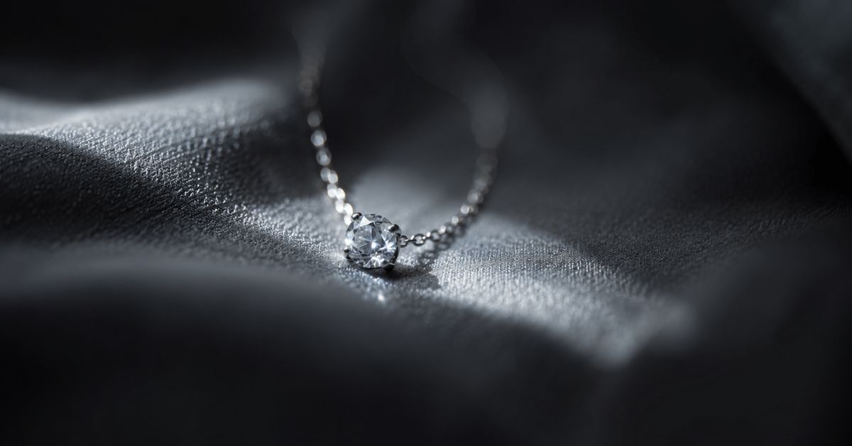 A delicate ring on draped fabric lit by a narrow beam of morning light | featured image for How Lucky I Am on Sayspire.