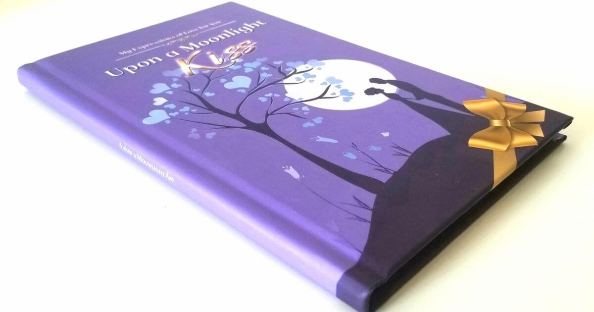 Hardcover of Upon a Moonlight Kiss by Joshua Cintron tied with a gold bow, a romantic poetry book gift